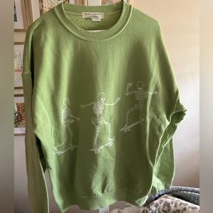 Green skeleton skateboarding. Project social T green crewneck